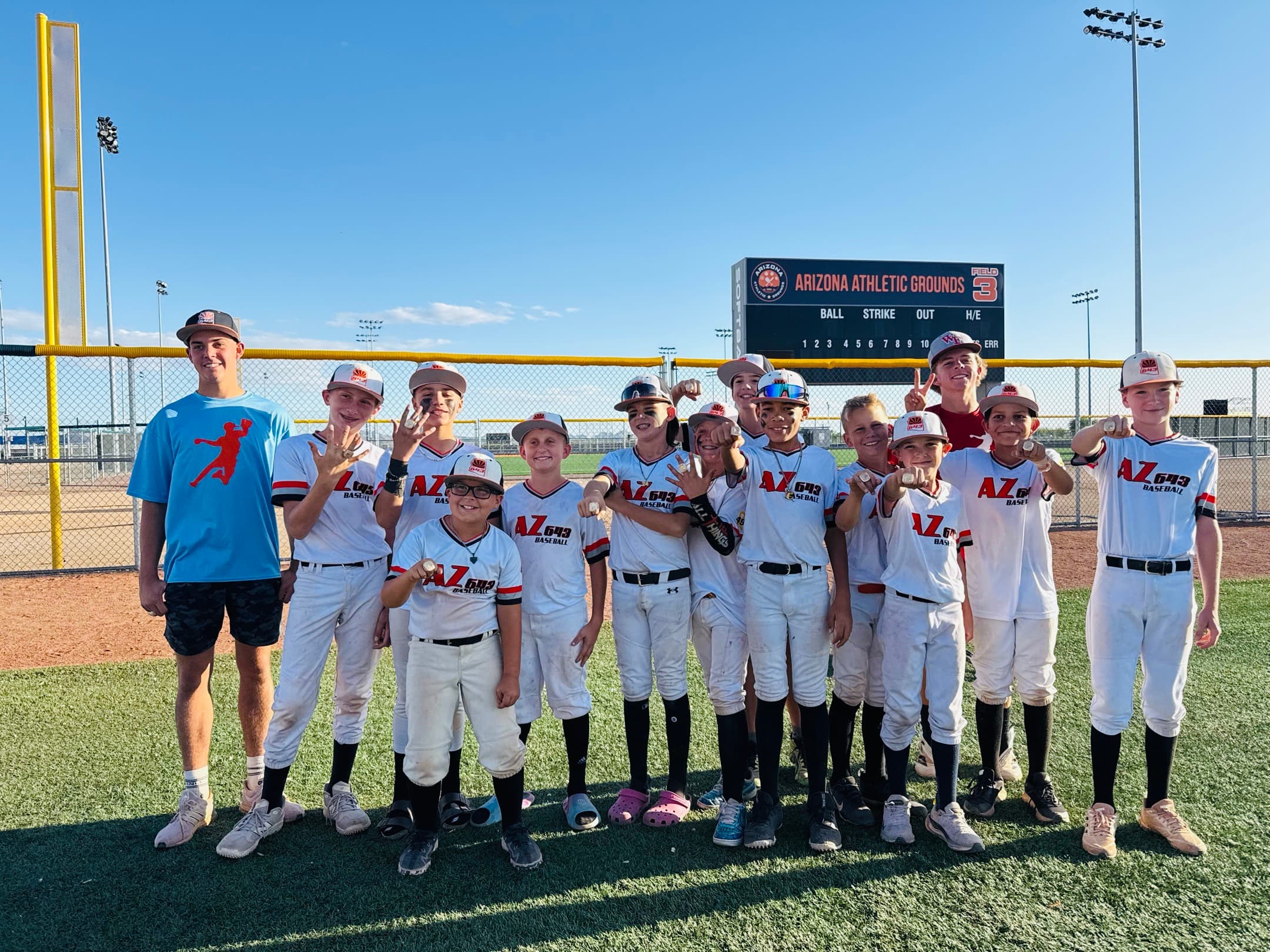 The AZ643 12U team and their coach on the field at Arizona Athletic Grounds